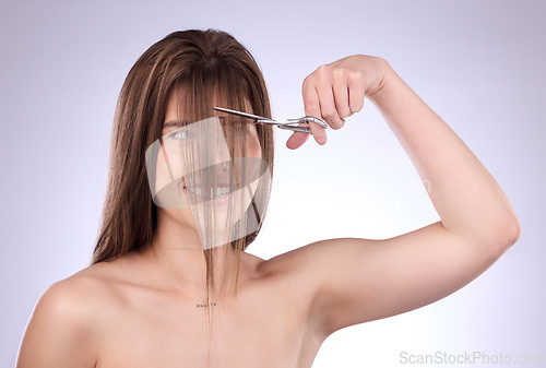 Image of Beauty, grooming and woman cutting her hair in studio on a gray background for style or care. Salon, shampoo and haircut with an attractive young female trimming her hairstyle for haircare