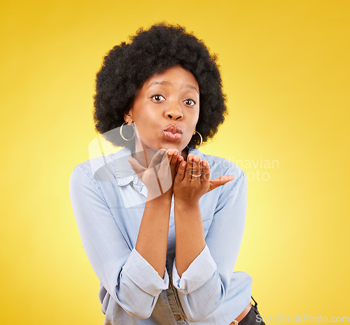 Image of Happy, blowing kiss and portrait of black woman in studio for confidence, flirting and romance. Self love, relax and desire with female on yellow background for positive, sensual and proud gesture