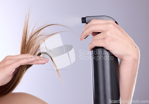 Image of Hair care, beauty and hands with spray in studio isolated on a gray background. Cosmetics product, keratin and model woman with hairspray bottle for salon treatment, growth and hairstyle moisturizer.