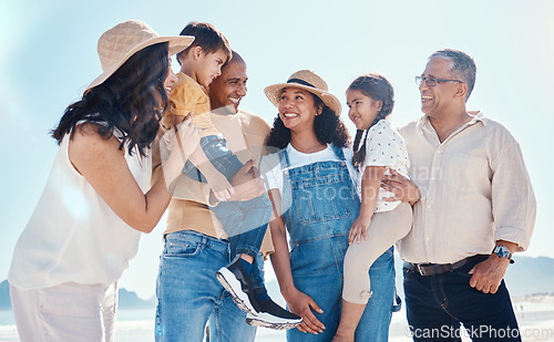 Image of Kids, beach and summer with a black family together outdoor on the sand by the ocean or sea for holiday. Children, love or nature with siblings, parents and grandparents bonding outside on the coast