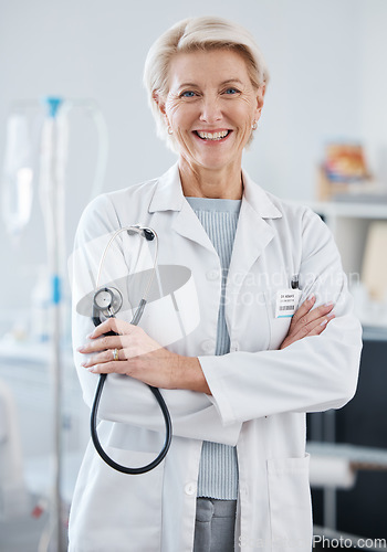 Image of Portrait, woman and doctor with arms crossed, stethoscope and happiness in hospital, clinic and surgery. Mature female medical worker smile for healthcare services, cardiology wellness and experience
