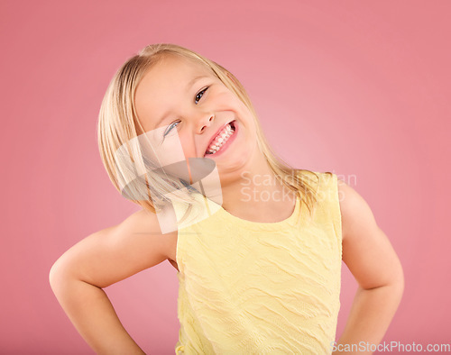 Image of Smile, cute and portrait of a posing child isolated on a pink background in a studio. Happy, adorable and an excited young girl with happiness, smiling and excitement with a pose on a backdrop