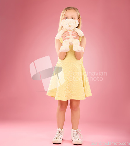 Image of Teddy, girl and portrait with a kids soft toy with happiness and love for toys in a studio. Isolated, pink background and a young female child feeling happy, joy and cheerful with bear friend