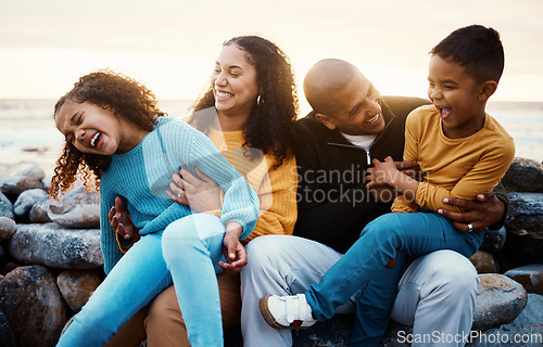 Image of Laughing, family and relax at beach on vacation, holiday or trip at sunset outdoors. Love, care and happy, bonding and funny children, father and mother with laughter for tickling, joke or comedy.