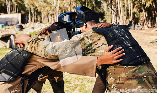 Image of Group, paintball or team in huddle planning strategy goals, or soldier training on war battlefield together. Community or army soldiers talking for support, collaboration or military people game