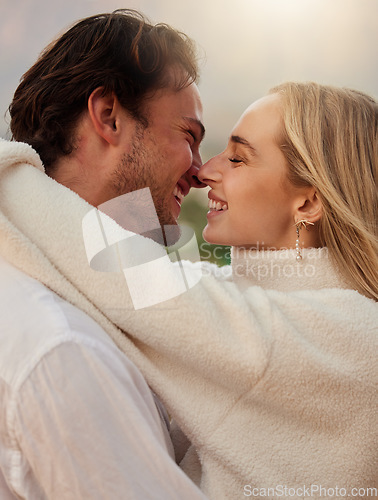 Image of Love, smile and kiss with couple in nature for romance, bonding and affectionate together. Sensual, happiness and embrace with man and woman hugging on date for sunset, anniversary and summer break