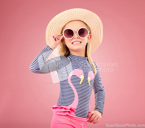 Image of Vacation, portrait of happy child with sunglasses and hat in studio with fun clothes isolated on pink background. Summer, holiday and fashion, girl in Australia excited for travel with smile on face.