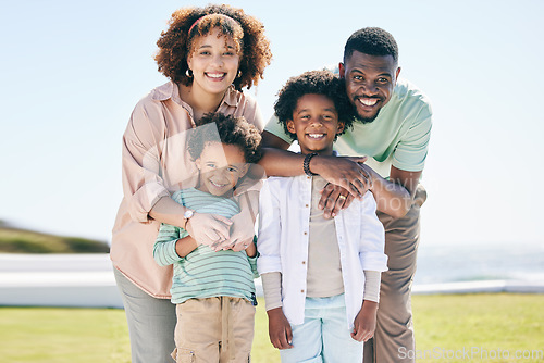 Image of Love, happy and portrait of a family at the beach on a summer vacation, adventure or weekend trip. Happiness, smile and parents posing and bonding with boy children by the ocean while on holiday.