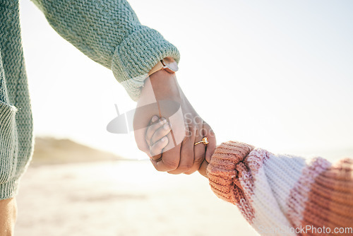 Image of Family, mother and kid holding hands at beach, travel and summer holiday with sunshine and together outdoor. Trust, support with woman and girl on vacation, love and care in nature with closeup