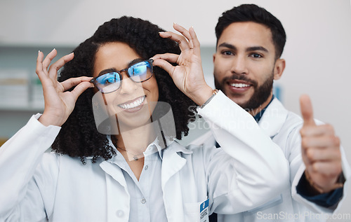 Image of Vision portrait, doctor thumbs up and smile of a female healthcare worker in a hospital. Agreement, glasses choice and happy woman looking at lens and frames options in a optometrist clinic