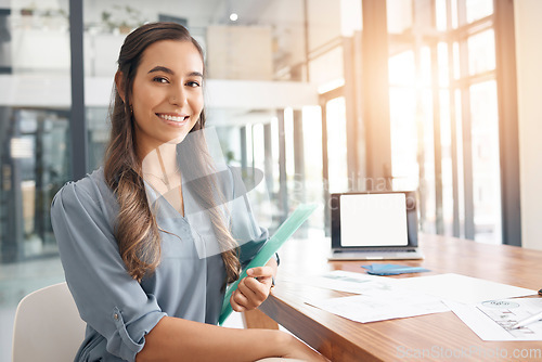 Image of Portrait, creative and smile with a designer woman at work in her office boardroom on a project. Marketing, design and happy with a young female employee working at a table or desk for advertising