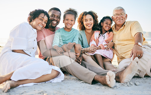 Image of Family at beach, portrait and generations, happy people relax outdoor with grandparents, parents and kids. Happiness, smile and sitting together on sand, travel and vacation with love and bond