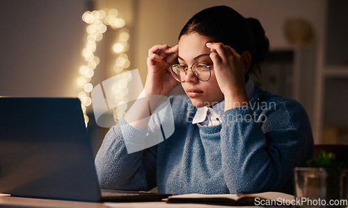 Image of Latino woman, headache and online stress at laptop of a student with learning burnout. Night, online university project and anxiety of a young female with glasses and blurred background in the dark