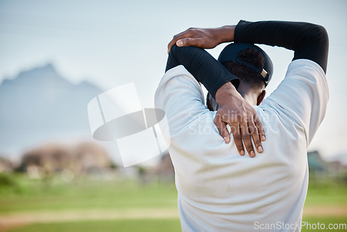 Image of Baseball field, back view or black man stretching in training ready for match on field in summer. Workout exercise, fitness mindset or focused young sports player in warm up to start playing softball