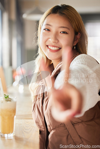 Image of Peace, hand gesture and portrait with an asian woman in a coffee shop, drinking a beverage or refreshment. Face, emoji and cafe with an attractive young female enjoying a smoothie or juice drink