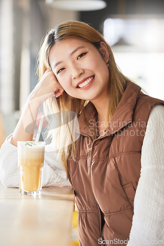 Image of Happy, cafe and portrait of a woman with a drink in the morning for breakfast at a coffee shop. Smile, happiness and beautiful Asian girl with a beverage at a restaurant for enjoyment and relaxation