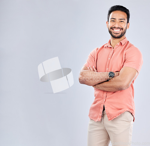 Image of Portrait, mockup and a man in studio, crossed arms standing on a gray background for branding or product placement. Marketing, advertising and mock up with a young male posing for fashion or style