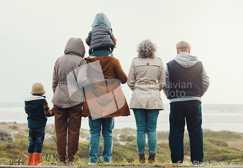 Image of Back, love and family on beach, morning and quality time for break, vacation and cheerful together. Grandparents, mother and father with siblings, children and seaside holiday to relax, cold and rest