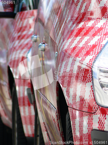 Image of Row of red and  white cars