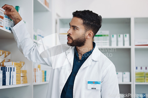Image of Pharmacy, medical and shelf with man in store for healthcare, drugs dispensary and treatment prescription. Medicine, pills and shopping with pharmacist for check, label information and product