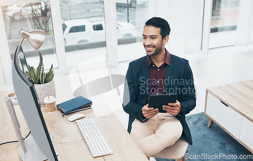 Image of Office, Indian man at desk with tablet and smile at computer, reading good news email or successful sales report online. Business, smile and communication with internet research, social media or web.