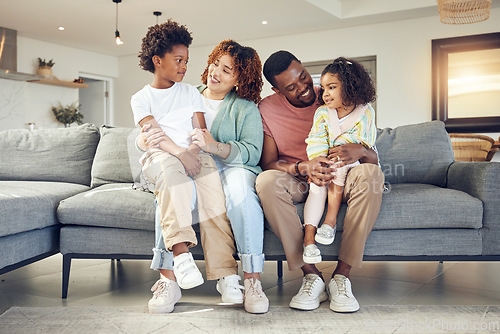 Image of Black family, love and bond on a sofa, happy and smile while talking and enjoying a morning in their home. Relax, children and parents on couch together, embrace and loving in living room on weekend