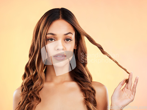 Image of Hair care, style and portrait of a woman with curls isolated on a yellow background in a studio. Split ends, strength and a girl showing the growth of hairstyle, results and promotion of a salon