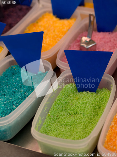 Image of plastic boxes filled with colored sweets powder