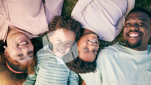 Image of Smile, black family lying on grass from above and happy face of mom, dad and children together. Weekend, relax and people in garden, top view of woman, man and kids with happiness and love in Africa.