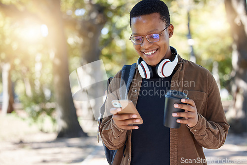 Image of Social media, park and black man with a phone and coffee for communication, connection and chat. Email, smile and African student reading a notification on a mobile app with a drink on a campus