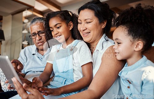 Image of Family, relax and girl with tablet in home living room for social media, video streaming or web browsing. Technology, smile or care of happy grandfather, grandma and children bonding with touchscreen