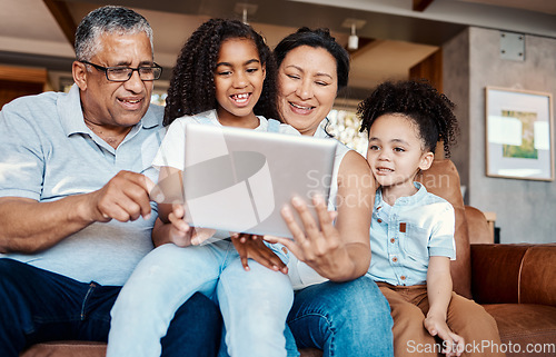 Image of Family, relax and girl with tablet on sofa in home living room for social media or funny video streaming. Technology, care and happy grandfather, grandma and kids laughing or bonding with touchscreen