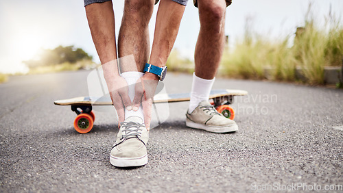 Image of Ankle pain, injury and skater with ache or hurt foot while skating on the road or street as extreme sport. Exercise, fitness and skateboarder with muscle strain in an emergency due to accident