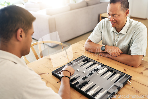 Image of Senior, man and play backgammon in home with focus, strategy and contest for thinking, moving or son by table. Elderly man, board game competition and relax with bonding, love and family house lounge