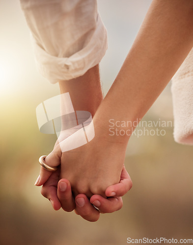 Image of Love, romance and couple holding hands at sunset for bonding, quality time and romantic anniversary. Dating, honeymoon and zoom of man and woman for trust on holiday, vacation and valentines day