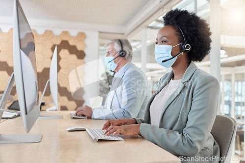 Image of Covid, masks and call center agents in compliance working as a team on customer service in an office typing. Computer, Consultant and telemarketing colleagues in a company doing technical support