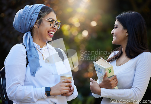 Image of Happy, break or students laughing in park on university campus for learning, education or books together. Girls talk, Islamic or funny friends relaxing or meeting for research or college knowledge