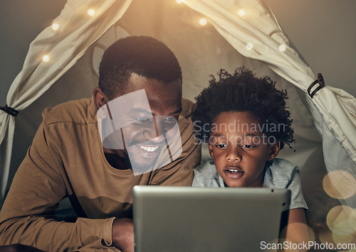 Image of Black family, tablet and father with kid in tent at night watching movie, video and having fun in home. Technology, bokeh and smile of happy dad bonding with boy child while streaming film in house.