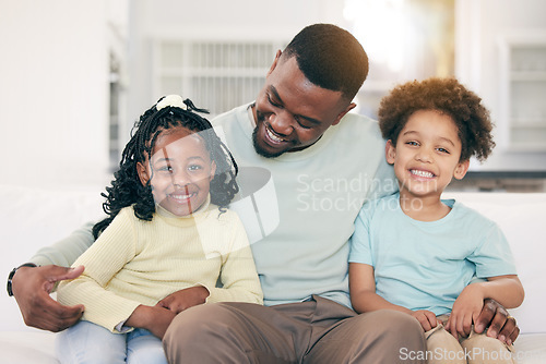 Image of Love, happy and father on a sofa with his children embracing, relaxing and bonding in the family home. Happy, smile and portrait of kids sitting with their dad in the living room of their house.