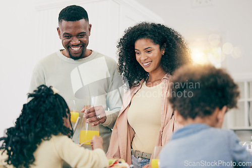 Image of Family, happiness and have breakfast together in home, mother and father with children, smile with juice and nutrition. Black people, joy and unity, bonding over meal, love and care in relationship