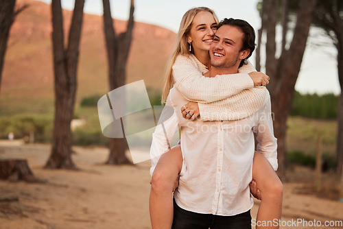 Image of Happy, love and sunset with couple and piggyback in nature for romance, affectionate and bonding. Happiness, relax and smile with man carrying woman on date for vacation, cute and sweet relationship