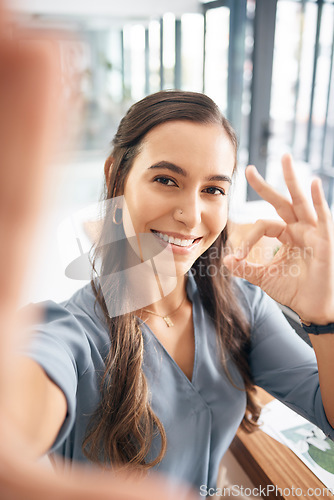 Image of Selfie, portrait and business woman with ok sign for success, agreement and perfect emoji in office. Picture, smile and happy female worker with hand gesture for okay, good job and yes icon at desk