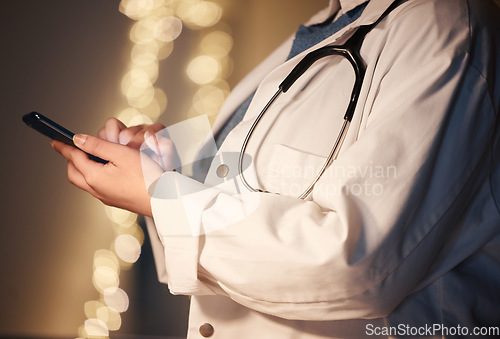 Image of Hands, texting and night for doctor, woman and reading social media app, networking or news on web. Medic, smartphone or website for medical journal, newspaper or research on internet at hospital job