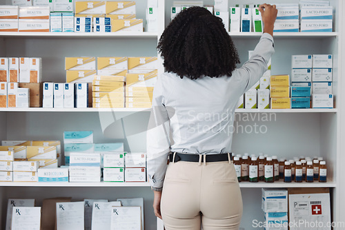 Image of Pharmacy, medicine and shelf with black woman in store for healthcare, drugs dispensary and treatment prescription. Medical, pills and shopping with pharmacist for check, label information or product