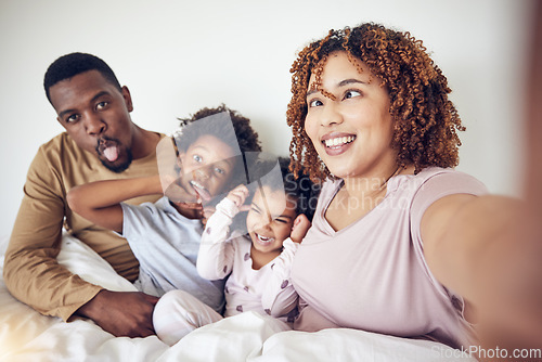 Image of Black family, selfie and funny face portrait in home bedroom, smile and having fun together. Interracial, comic and father, mother and children taking pictures for happy memory and social media.