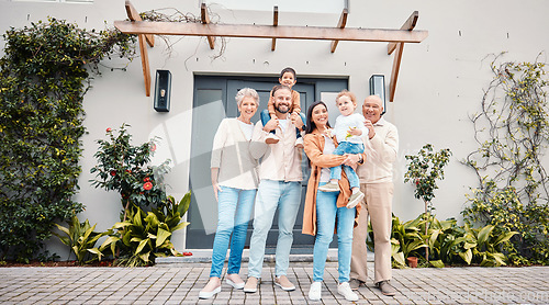 Image of Portrait of generations of family outside new home, real estate, investment and mortgage with security. Happy grandparents, parents and children standing together, homeowners with smile and happiness