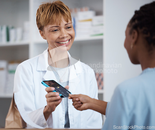 Image of Pharmacy, pharmacist and credit card payment of customer for medication, medicine or product in store. Senior healthcare, fintech smile and happy woman shopping for medical drugs with pos machine.