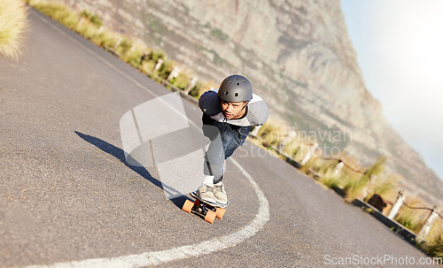 Image of Skateboard, fitness and mountain with man in road for speed, freedom and summer break. Sports, adventure and wellness with guy skating fast in street for training, gen z and balance in nature