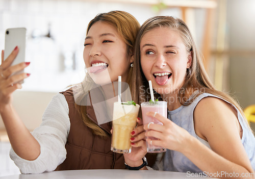 Image of Selfie, wink or funny friends take profile picture in cafe with happy smile on holiday vacation or weekend. Crazy faces, Asian or young women smiling for social media posts brunch date with cocktails