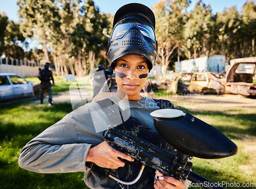 Image of Paintball, serious or portrait of woman with gun in shooting game playing in action battlefield mission. War, hero or focused soldier with army weapons gear in survival military challenge competition